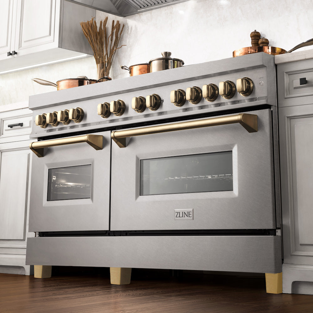 ZLINE Autograph Edition 60 in. 7.4 cu. ft. Dual Fuel Range with Gas Stove and Electric Oven in DuraSnow® Stainless Steel with Polished Gold Accents (RASZ-SN-60-G) from below in a luxury kitchen with cookware on cooktop.