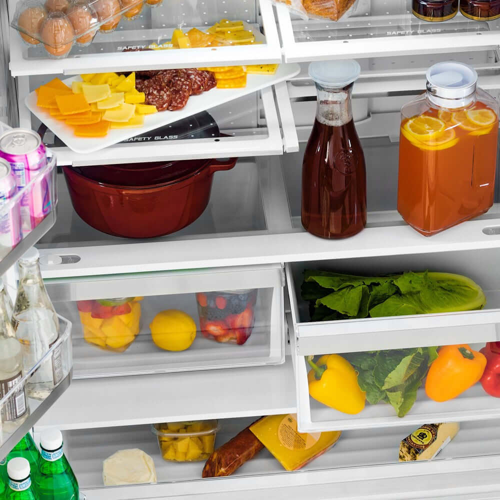 Food and drinks on adjustable shelving in refrigeration compartment from above.