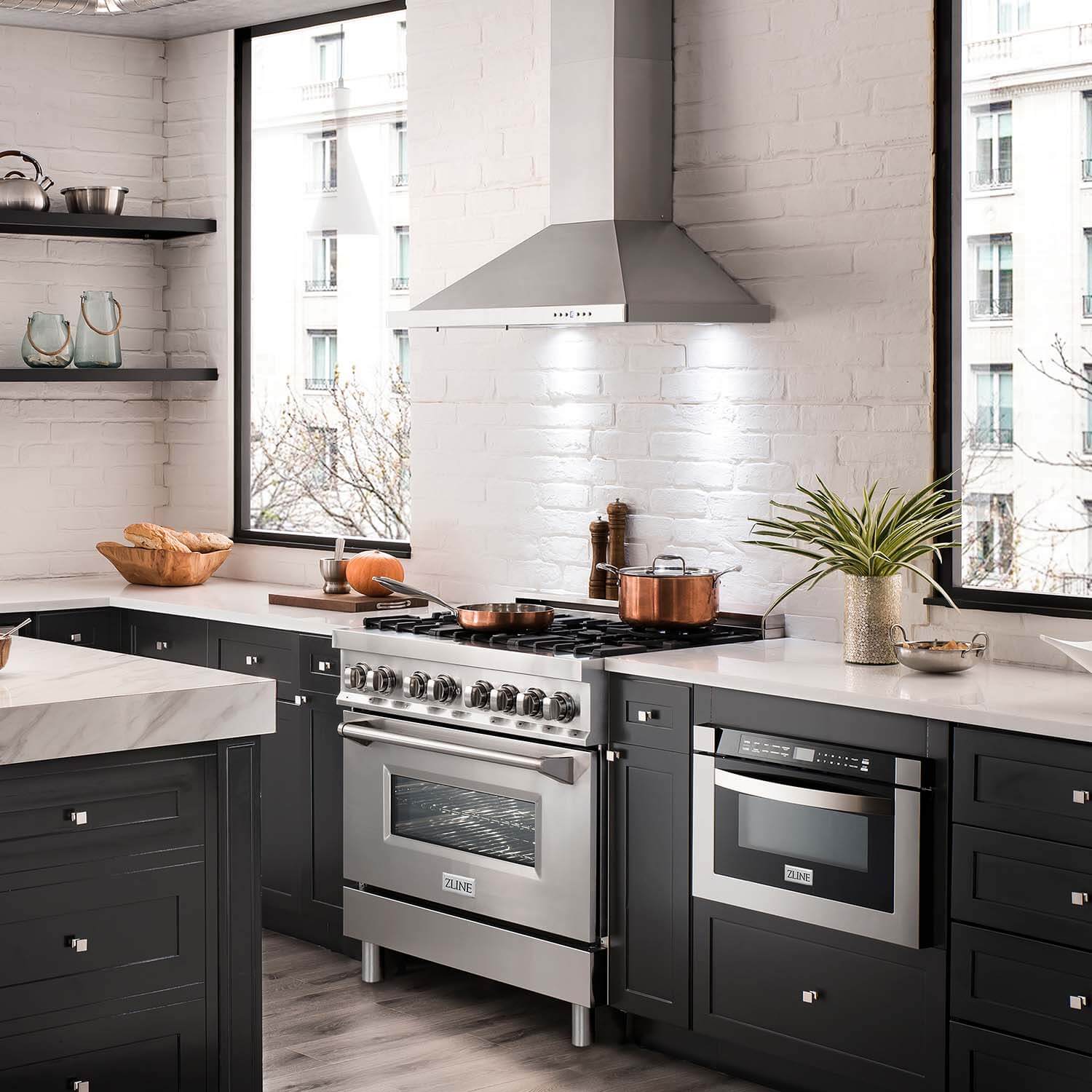 ZLINE appliance package with 36" range, 36" range hood, and microwave drawer in an apartment kitchen.
