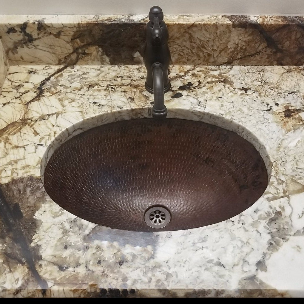 Premier Copper Sink Drain in Oil Rubbed Bronze in copper sink with marble counter