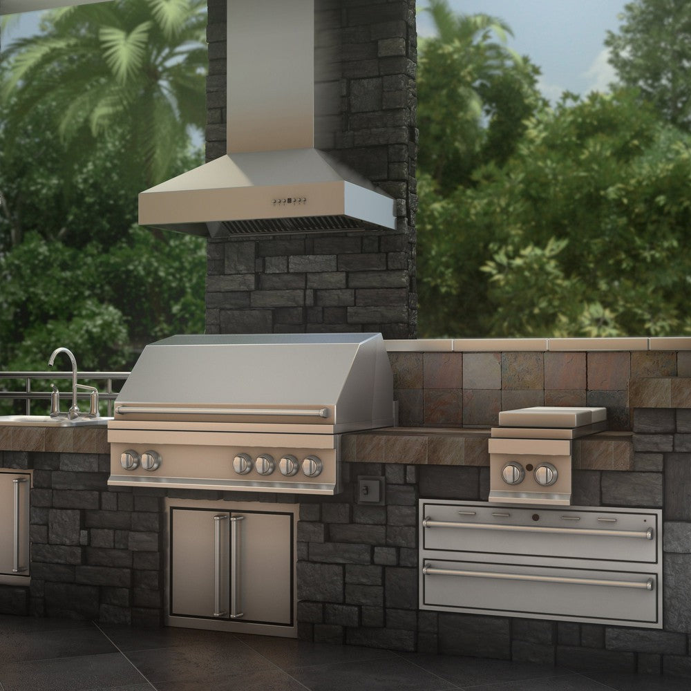 ZLINE Ducted Wall Mount Range Hood in Outdoor Approved Stainless Steel (697-304) rendering above barbecue in outdoor kitchen.