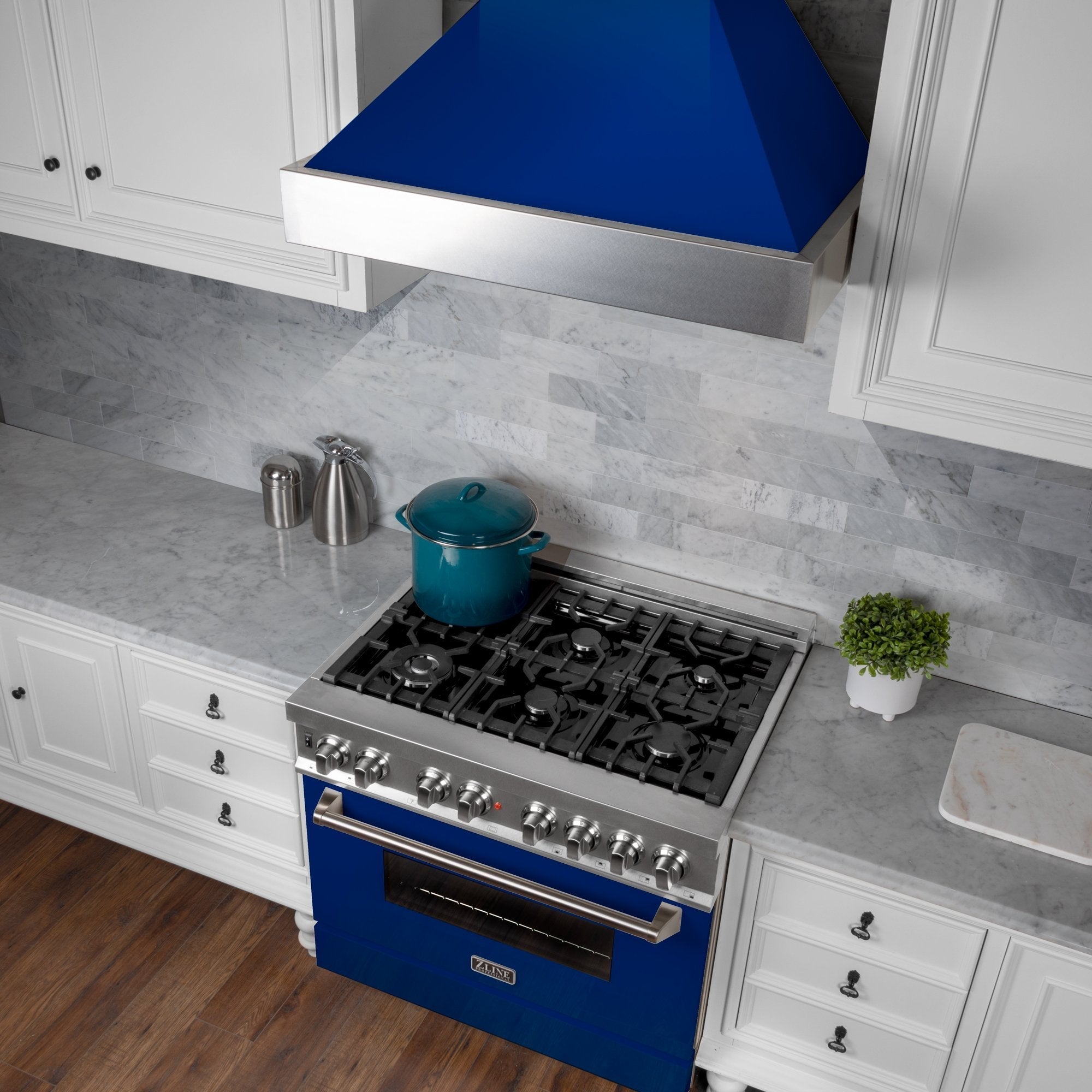 ZLINE Ducted Fingerprint Resistant Stainless Steel Range Hood with Blue Gloss Shell (8654BG) with short chimney in a kitchen with matching blue gloss range from above.