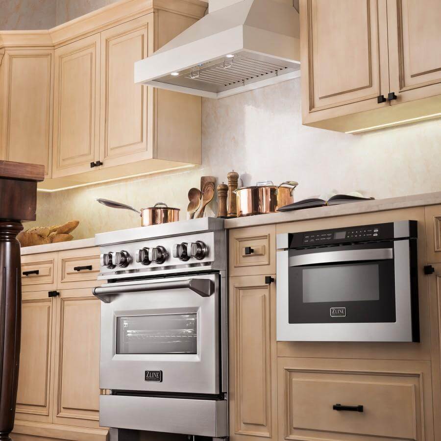 ZLINE Ducted Wooden Wall Mount Range Hood in Cottage White (KBTT) above a matching range in a farmhouse-style kitchen