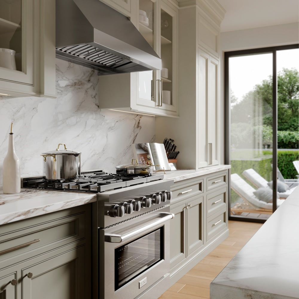 A kitchen with green cabinets and white countertops with ZLINE appliances.