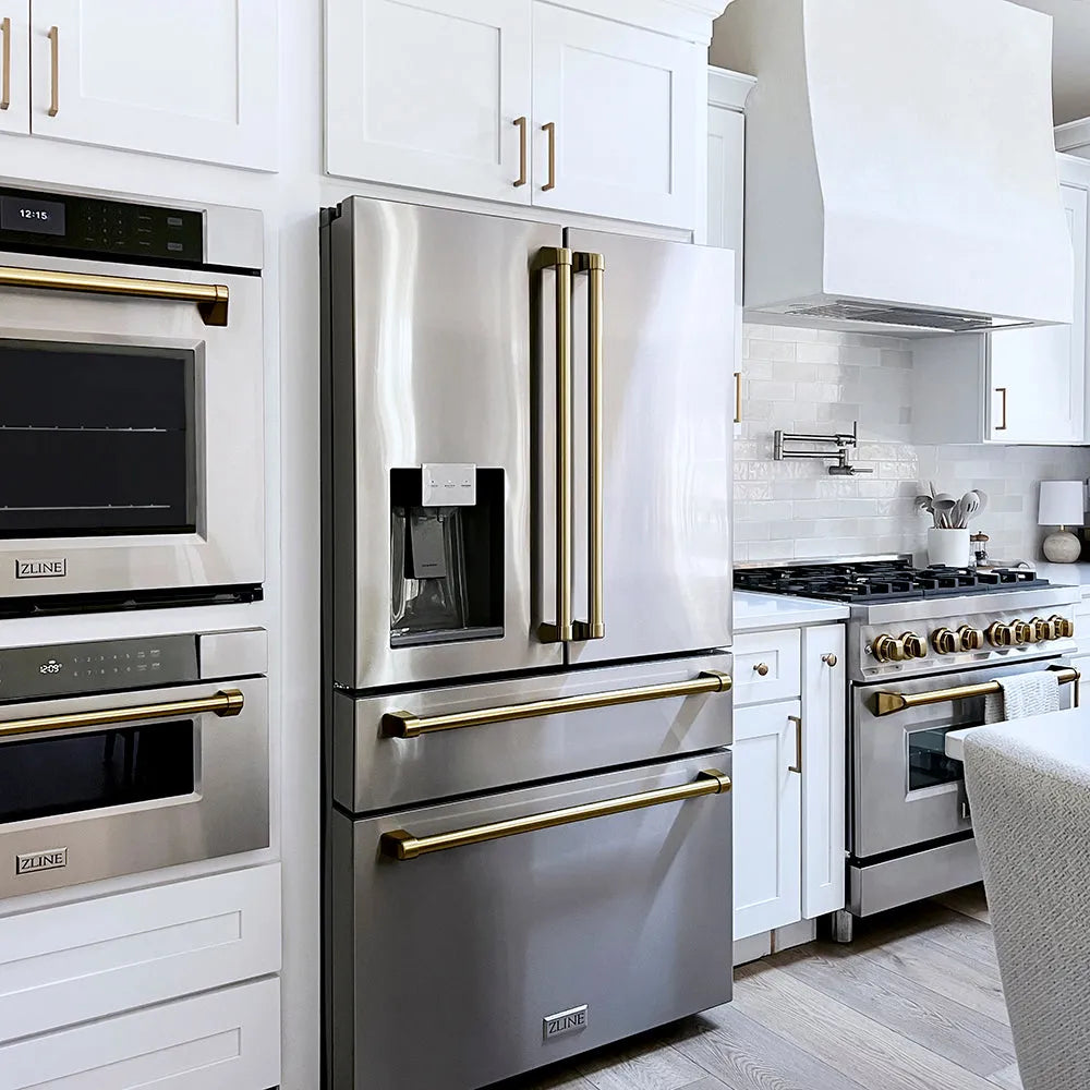 Modern farmhouse kitchen with stainless steel appliances, including a ZLINE Autograph Edition 36 in. 21.6 cu. ft. Counter-Depth French Door Refrigerator with Water and Ice Dispenser in Fingerprint-Resistant Stainless Steel with Champagne Bronze Traditional Handles (RFMZ-W-36-CB), oven, and range.