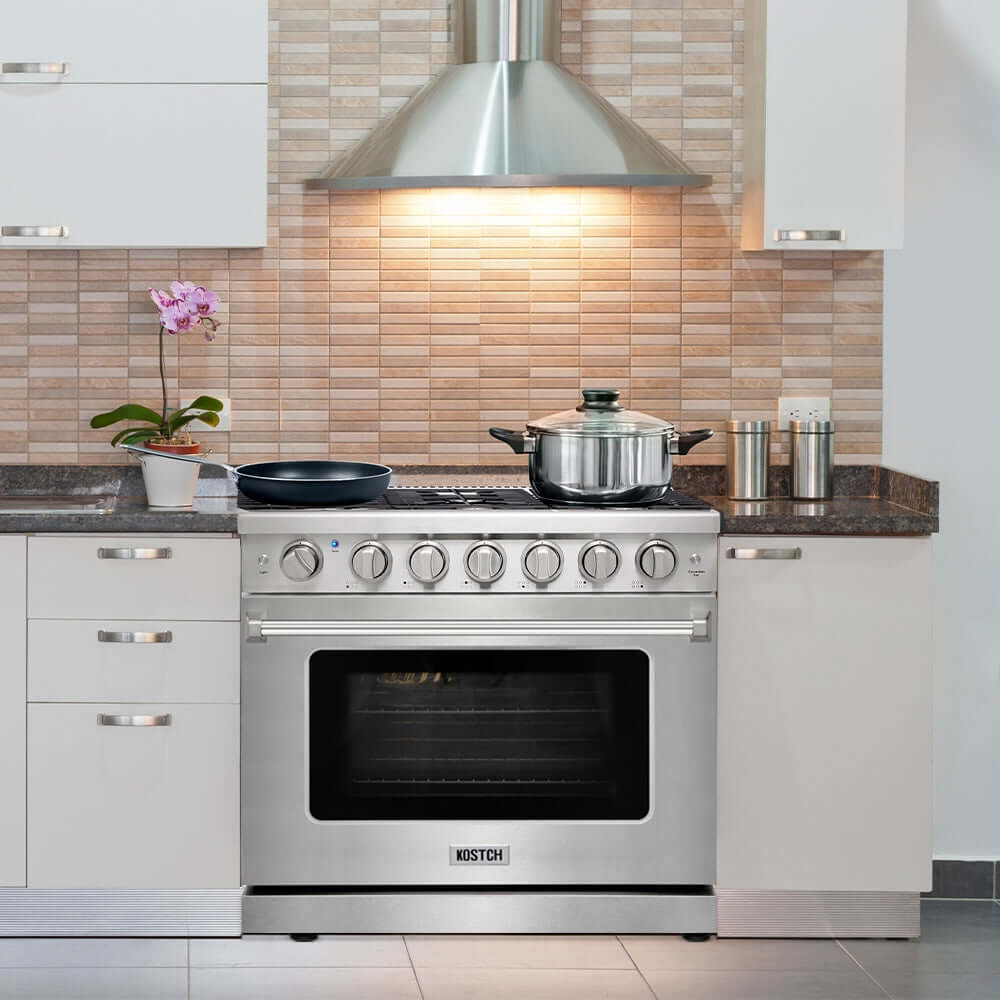 KOSTCH 36 in. Liquid Propane Gas Range with 6 Burners and 6.0 cu. ft. Convection Oven in Stainless Steel (KOS-36RG03MLP-S) with pots on a tiled backsplash