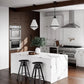 ZLINE Convertible Vent Wall Mount Range Hood in Stainless Steel (KL2) in a rustic white and wood kitchen.
