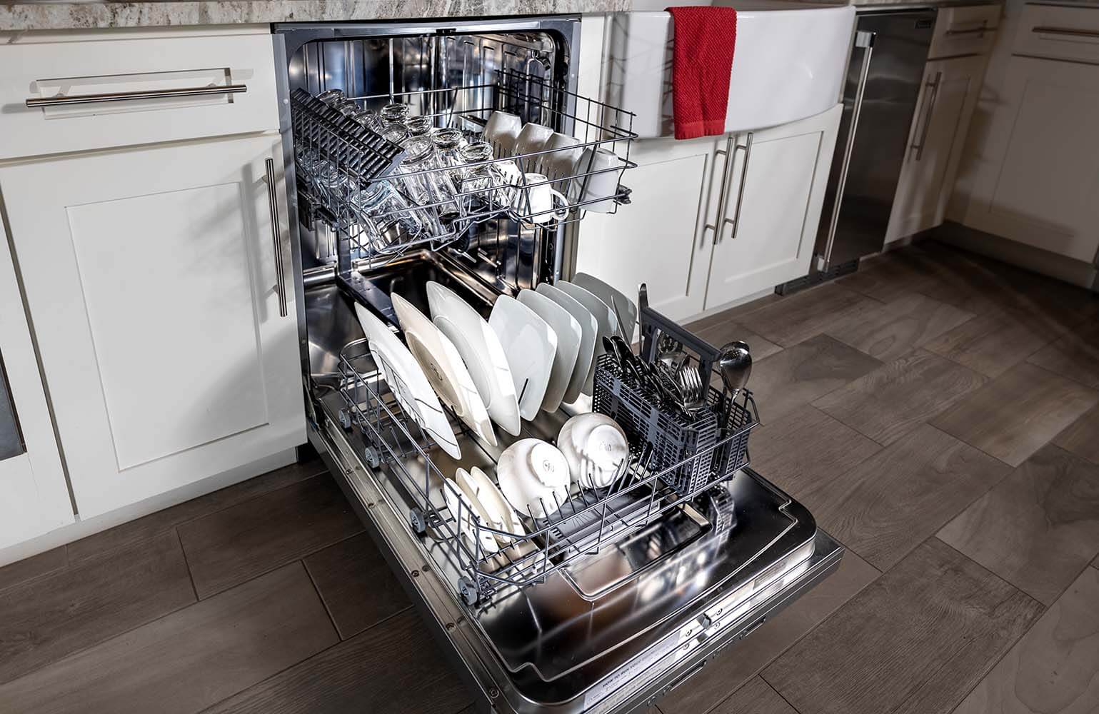 BREDA dishwasher loaded with dishes in kitchen