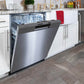 BREDA built-in dishwasher partially open in kitchen showroom.