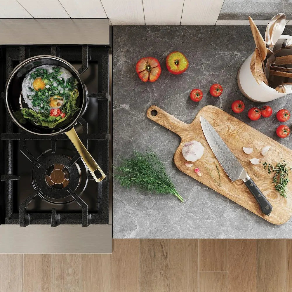 Stovetop with pan of food and kitchen counter with cutting board, knife, and vegetables.