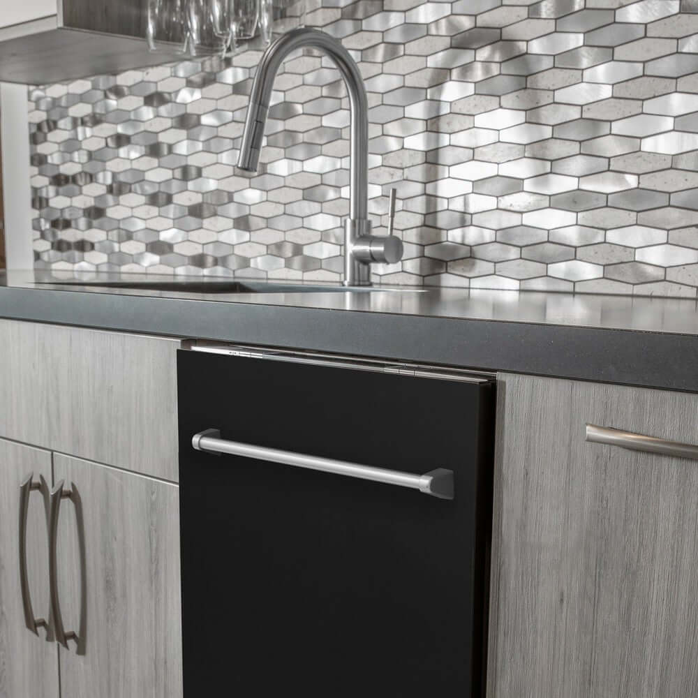 ZLINE 24 in. Black Matte Top Control Built-In Dishwasher with Stainless Steel Tub and Traditional Style Handle, 52dBa (DW-BLM-24) in a modern-style kitchen with grey cabinets and dark countertops.