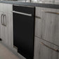 ZLINE 24 in. Black Matte Top Control Built-In Dishwasher with Stainless Steel Tub and Modern Style Handle, 52dBa (DW-BLM-H-24) in a modern-style kitchen with grey cabinets and dark countertops.