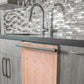 ZLINE 24 in. Unfinished Top Control Built-In Dishwasher with Stainless Steel Tub and Modern Style Handle, 52dBa (DW-UF-24) in a modern-style kitchen with grey cabinets and dark countertops.