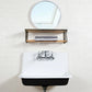 Kingston Brass 30 in. Cast Iron Single Bowl Wall Mount Sink with Backsplash in White (GCLWS302019) with silver faucet, wooden shelf above, and round mirror on white tiled wall.