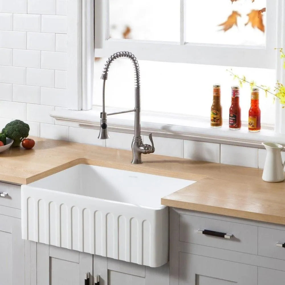 Kitchen with Kingston Brass 30 in. Solid Surface White Stone Apron-Front Single Bowl Farmhouse Kitchen Sink with Strainer in Matte White (GKFA301810CD), wooden countertop, and decorative elements.