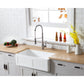 Farmhouse kitchen with a Kingston Brass 33 in. Solid Surface White Stone Apron-Front Single Bowl Farmhouse Kitchen Sink with Strainer in Matte White (GKFA331810DS), wooden countertop, and decorative elements.