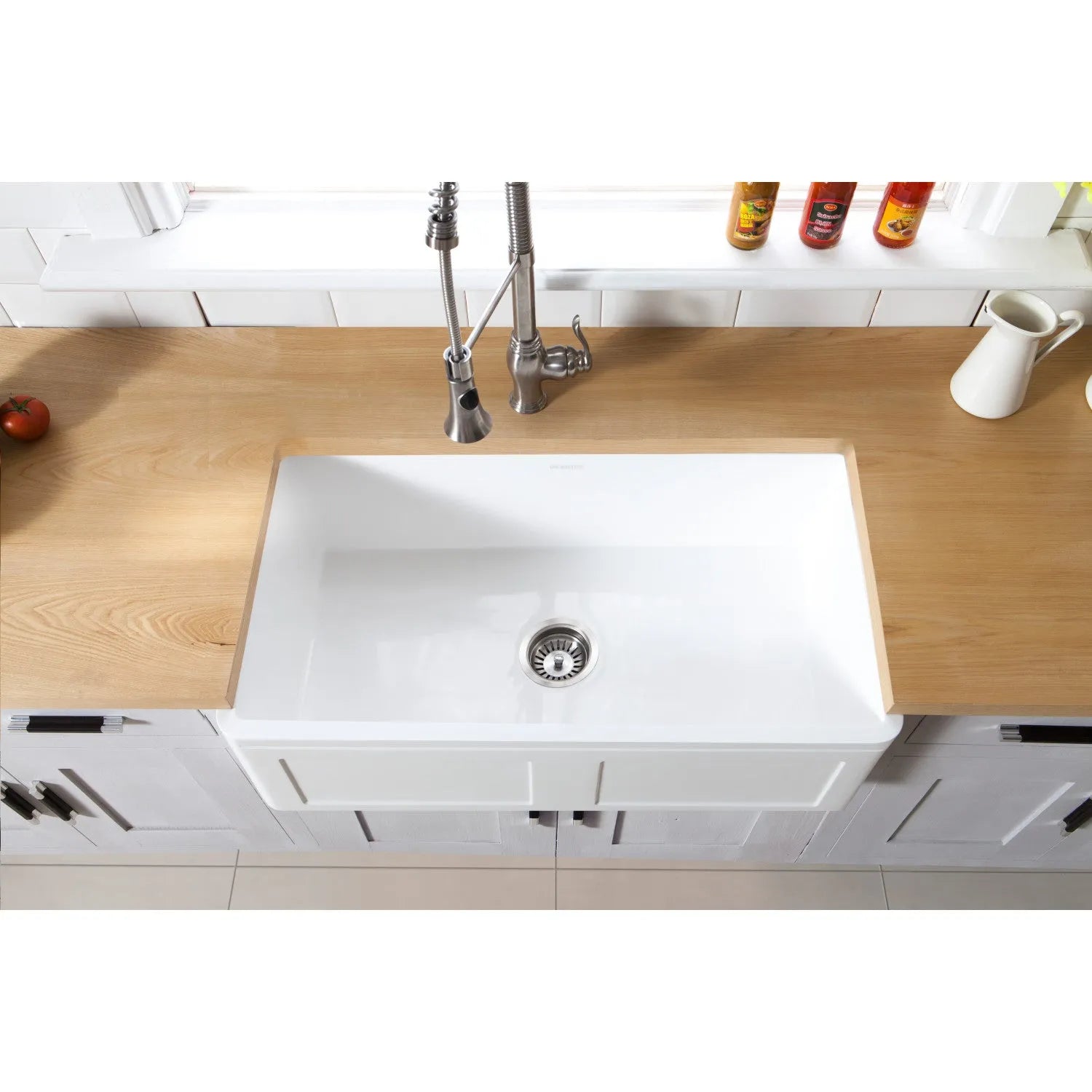 Kingston Brass 33 in. Solid Surface White Stone Apron-Front Single Bowl Farmhouse Kitchen Sink with Strainer in Matte White (GKFA331810DS) with wooden countertop and tiled wall