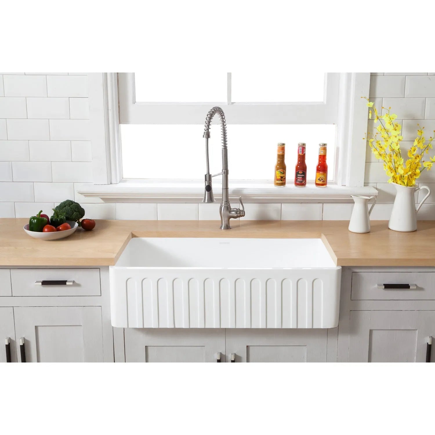 Farmhouse kitchen with Kingston Brass 36 in. Solid Surface Matte Stone Apron Front Farmhouse Single Bowl Kitchen Sink in Matte White (GKFA361810CD), wooden countertop, and decorative elements.