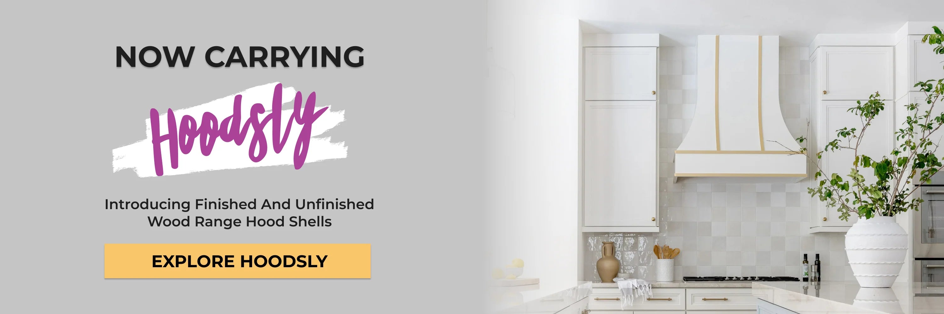 Promotional graphic for Hoodsly showing a white kitchen range hood with gold trim in a bright kitchen setting, with text reading 'NOW CARRYING HOODSLY' and 'Introducing Finished And Unfinished Wood Range Hood Shells'. Button: Explore Hoodsly.