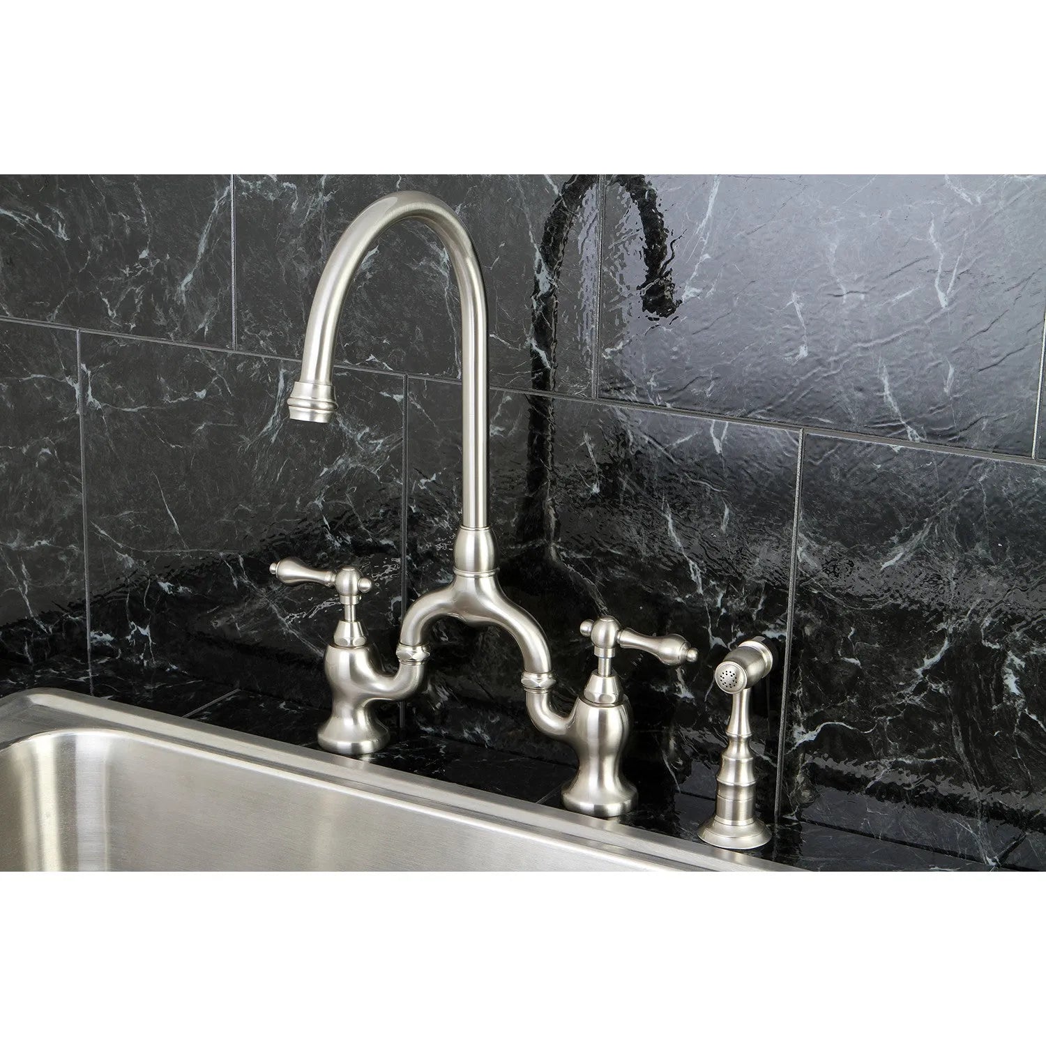 Kingston Brass English Country Kitchen Bridge Faucet with Brass Sprayer (KS7792ALBS) Brushed Nickel on a black marble backsplash