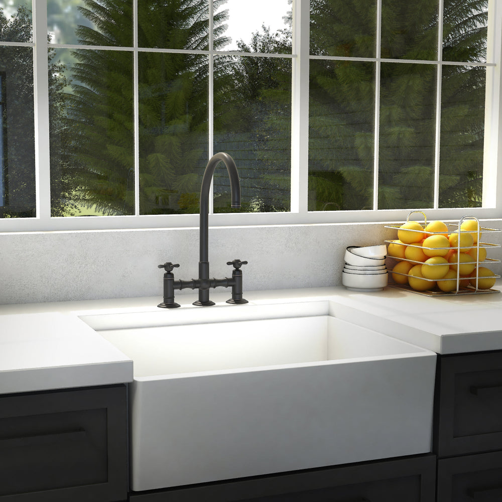 ZLINE Mona Kitchen Faucet (MNA-KF) Oil Rubbed Bronze in a kitchen with a white sink and window view of greenery.