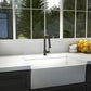 Modern kitchen with a white sink and ZLINE Monet Kitchen Faucet in Matte Black (MON-KF-MB), large window with greenery outside.