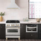 ZLINE Autograph Edition 30 in. Stainless Steel Range Hood with Stainless Steel Shell and Handle (8654STZ-30) in modern luxury apartment kitchen above matching range.