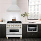 ZLINE Autograph Edition 36 in. Stainless Steel Range Hood with Stainless Steel Shell and Handle (8654STZ-36) in modern luxury apartment kitchen above matching range.