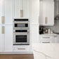 ZLINE Autograph Edition 30 in. 1.6 cu ft. Built-in Convection Microwave Oven in Satin Stainless Steel and Champagne Bronze Accents (MWOZ-30-SS-CB) in a luxury kitchen with white cabinets, stainless steel appliances, and marble countertop.