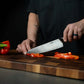 ZLINE Mark Estee 8 in. Professional Japanese Damascus Steel Chef Knife (KCKT-ME-JD) close-up, Mark Estee using the knife.