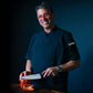 ZLINE Mark Estee 8 in. Professional Japanese Damascus Steel Chef Knife (KCKT-ME-JD) Mark Estee using the knife.
