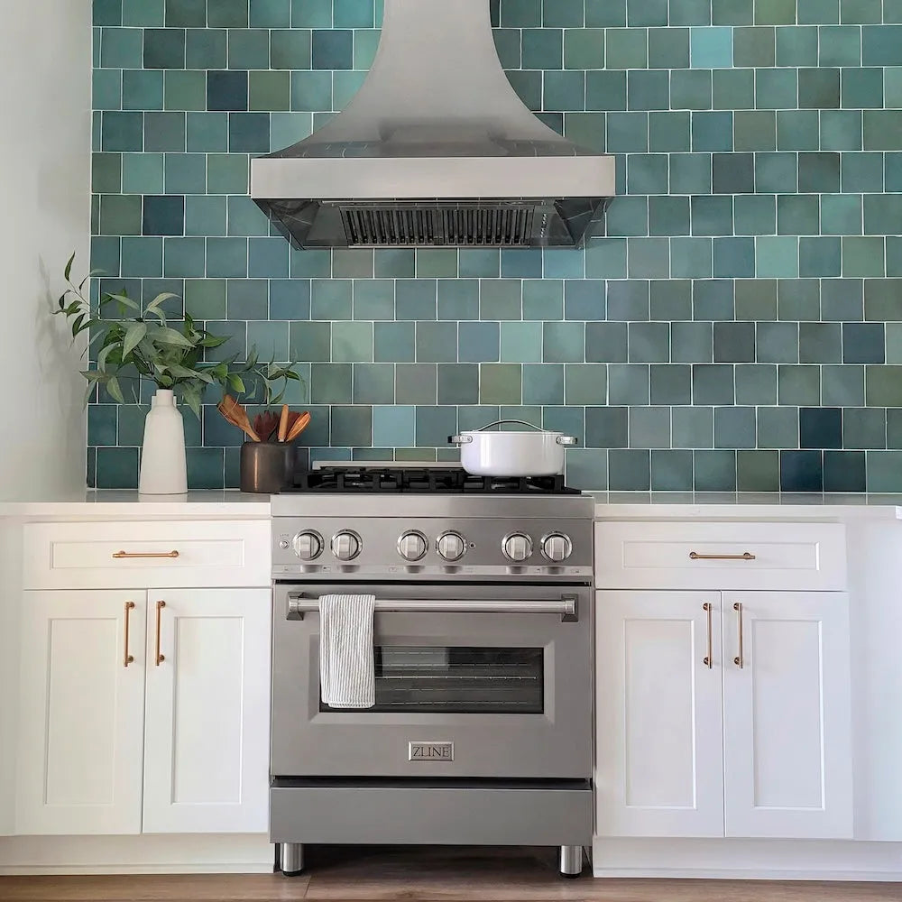 Custom kitchen with Satin stainless steel range and green tiled backsplash