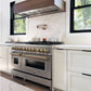 Farmhouse kitchen with a ZLINE Autograph Edition 48 in. 6.0 cu. ft. Legacy Dual Fuel Range with 7 Burner Gas Cooktop and 2 Electric Ovens in Stainless Steel and Champagne Bronze Accents (RAZ-48-CB) and marble countertop