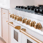 ZLINE Autograph Edition 48 in. 6.0 cu. ft. Legacy Dual Fuel Range with 7 Burner Gas Cooktop and 2 Electric Ovens in Stainless Steel with White Matte Doors and Polished Gold Accents (RAZ-WM-48-G) close-up gold handles and knobs.