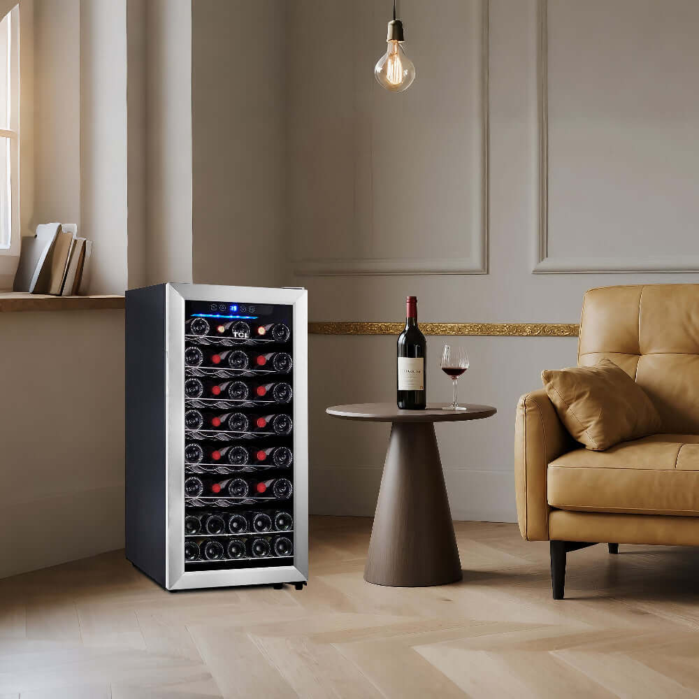TCL 16 in. 38 Bottle 3.4 Cu. Ft. Compact Wine Cooler with Glass Door (TRW38F6AS) with wine bottles in a living room setting