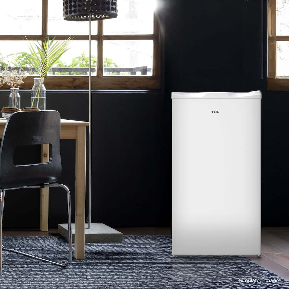 TCL 18 in. 3.1 Cu. Ft. Compact Single Door Mini Fridge in White (TRM31S4AW) in a room with a dining table and chairs.