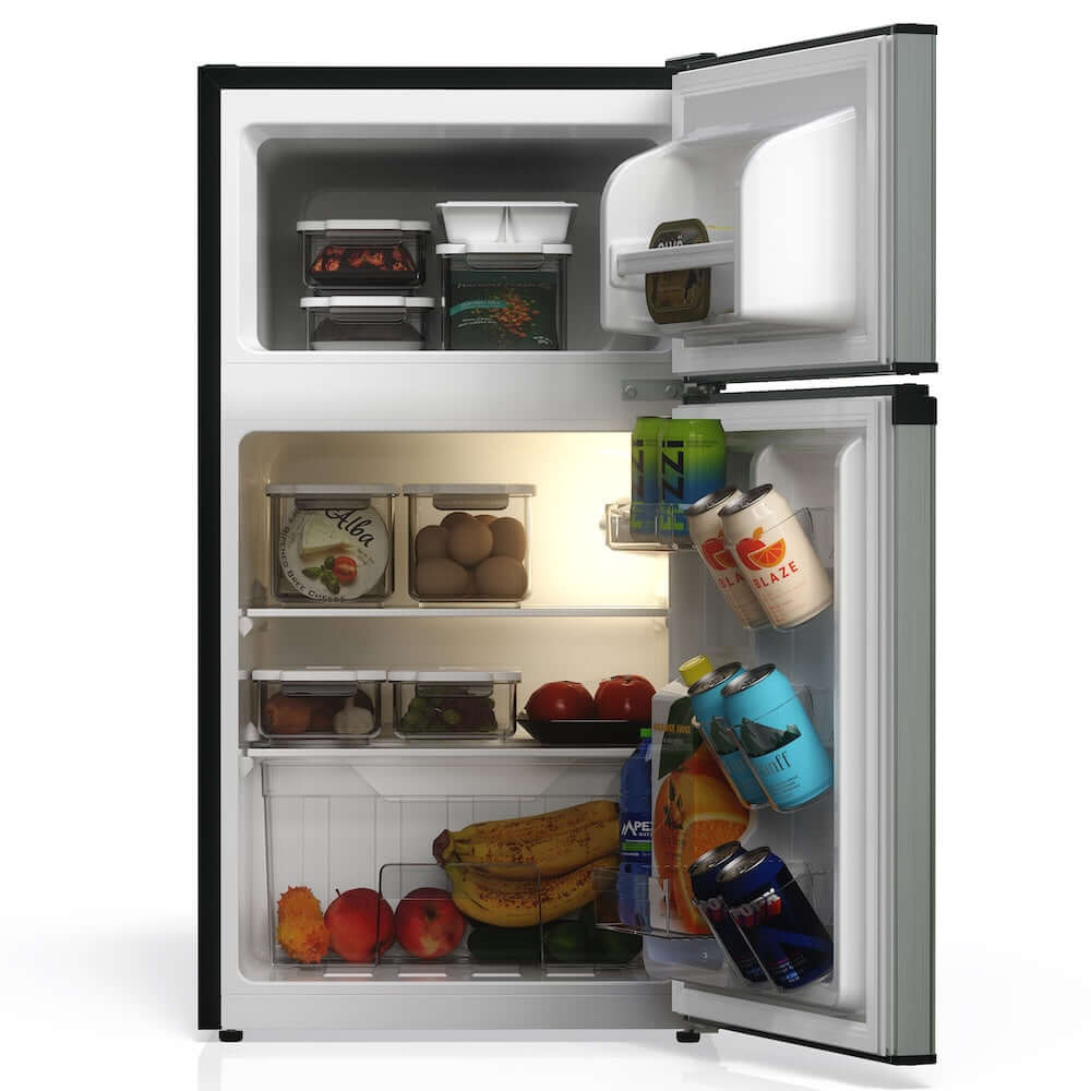 TCL 18 in. 3.1 Cu. Ft. Compact Top Freezer Mini Fridge in Silver (TRM31D4AV) with open door showing food and drinks inside on a white background