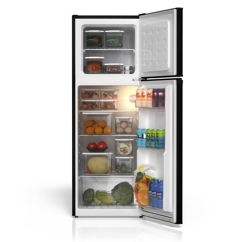 Open TCL 18 in. 4.7 Cu. Ft. Compact Top Freezer Mini Fridge in Black (TRM47D5AB) with food items, light on, on a white background