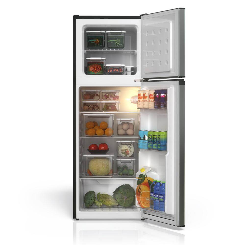 Open TCL 18 in. 4.7 Cu. Ft. Compact Top Freezer Mini Fridge in Silver (TRM47D5AV) with food items, light on, on a white background