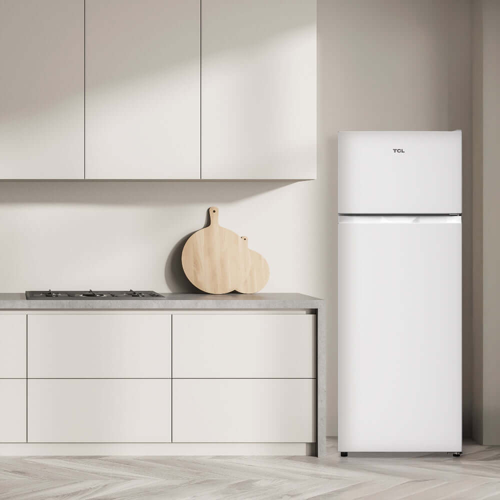 TCL 22 in. 7.3 Cu. Ft. Compact Top Freezer Refrigerator in White (TRT07T4AW) in a modern kitchen with light gray cabinets and wooden cutting board.