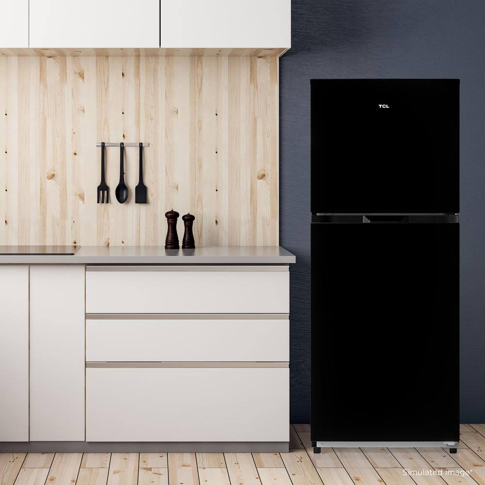 TCL 24 in. 10.1 Cu. Ft. Top Freezer Refrigerator in Black (TRT10T4AB) in a modern kitchen against a gray wall