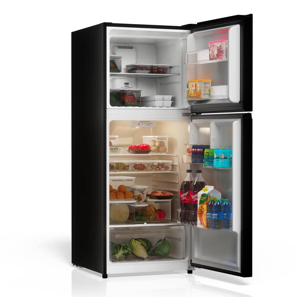 TCL 24 in. 10.1 Cu. Ft. Top Freezer Refrigerator in Black (TRT10T4AB) open with food items on a white background