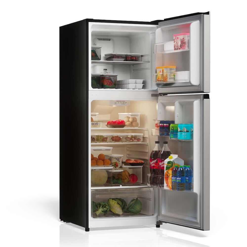 TCL 24 in. 10.1 Cu. Ft. Top Freezer Refrigerator in Silver (TRT10T4AL) side, open, with food items on a white background