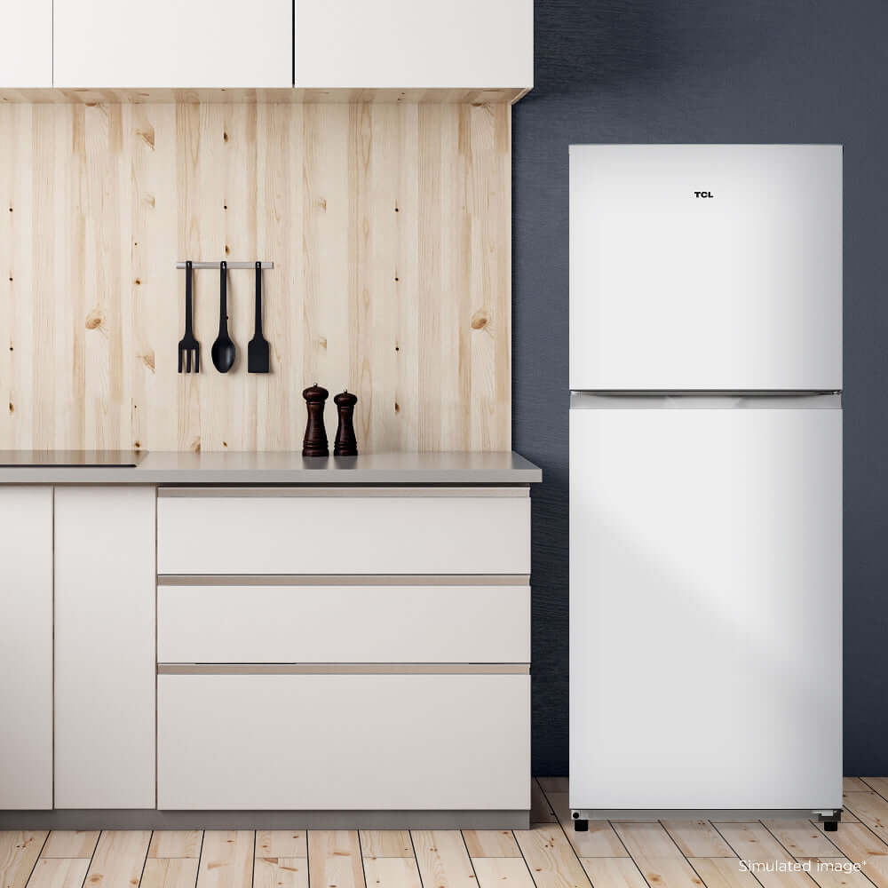 TCL 24 in. 10.1 Cu. Ft. Top Freezer Refrigerator in White (TRT10T4AW) in a modern kitchen with wooden wall and cabinets.