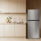 TCL 24 in. 11.6 Cu. Ft. Top Freezer Counter-Depth Refrigerator in Silver (TRT12T4AL) in a modern kitchen.