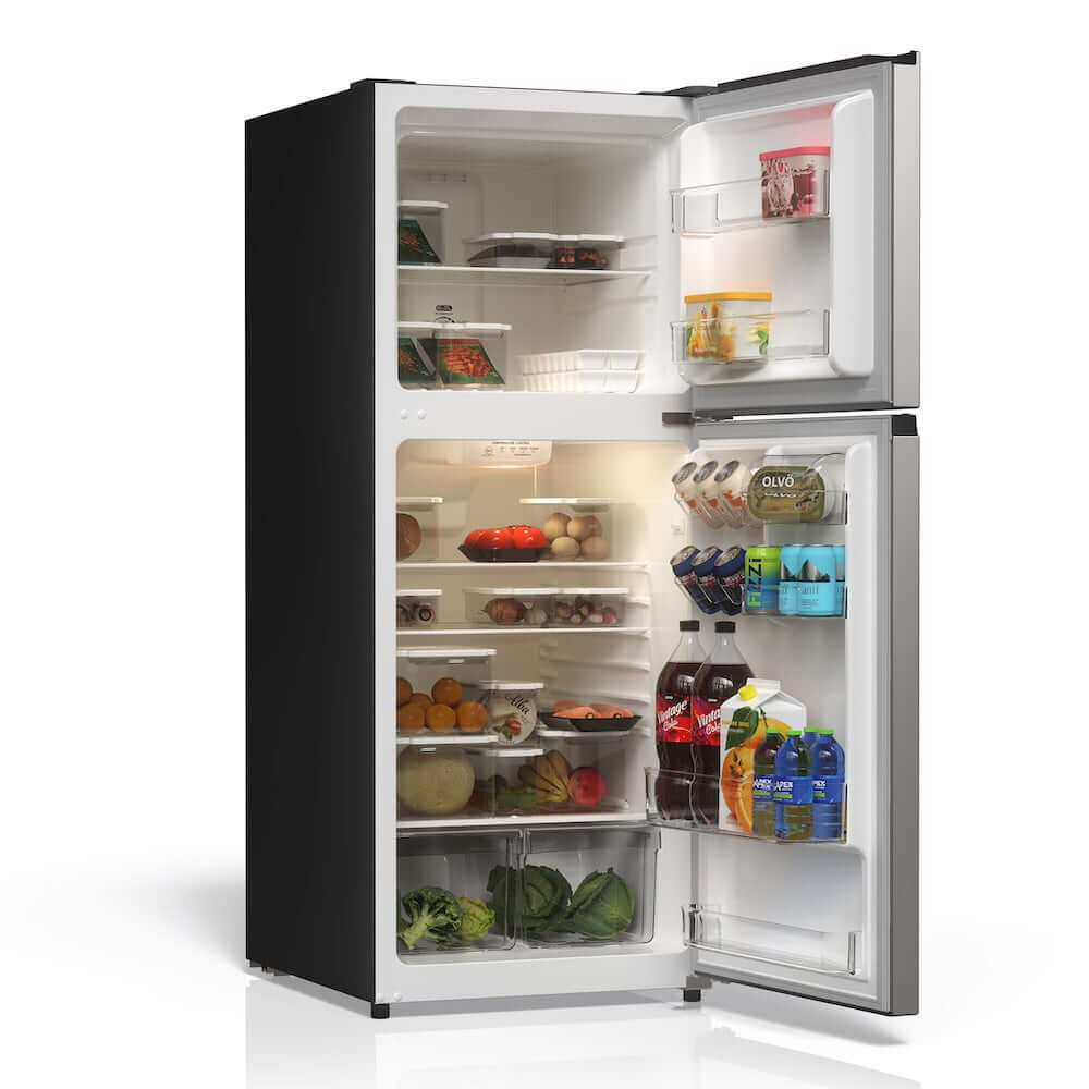 Open TCL 24 in. 11.6 Cu. Ft. Top Freezer Counter-Depth Refrigerator in Silver (TRT12T4AL) with food items on a white background