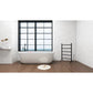 Modern bathroom with a freestanding bathtub, Kingston Brass Templeton Freestanding/Wall Mount Hardwired or Plug-In Towel Warmer Matte Black, and large window.