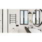 Modern bathroom interior with Kingston Brass Templeton Freestanding/Wall Mount Hardwired or Plug-In Towel Warmer Matte Black, window, and round mirror.