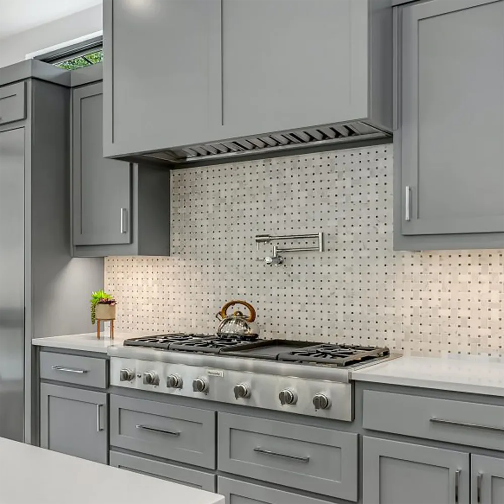 Modern kitchen with custom gray range hood using VICTORY Q2 700 CFM Insert Range Hood in Stainless Steel, stove, and backsplash.