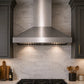 Modern kitchen with VICTORY Twister 750 CFM Wall Mount Range Hood in Stainless Steel, dark cabinets, and tiled backsplash.